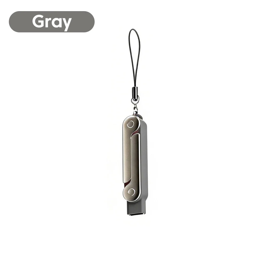 Gray USB-C male to female adapter with a foldable stand and keychain.
