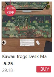 A green desk mat featuring a detailed nature scene with plants and insects, displayed next to a computer setup.