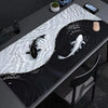 A black mouse pad featuring an artistic design of a whale shark swimming through white, wavy water.