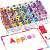 A clear plastic tray filled with multi-color letter fridge magnets arranged alphabetically.