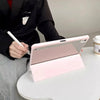 A pink acrylic protective skin is shown resting on a white table next to a person's hand.