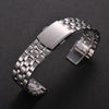 A stainless steel watch band with a folding safety clasp shown on a dark background.