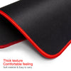 Black gaming mouse pad with a red stitched edge showing its thick texture and comfortable feel