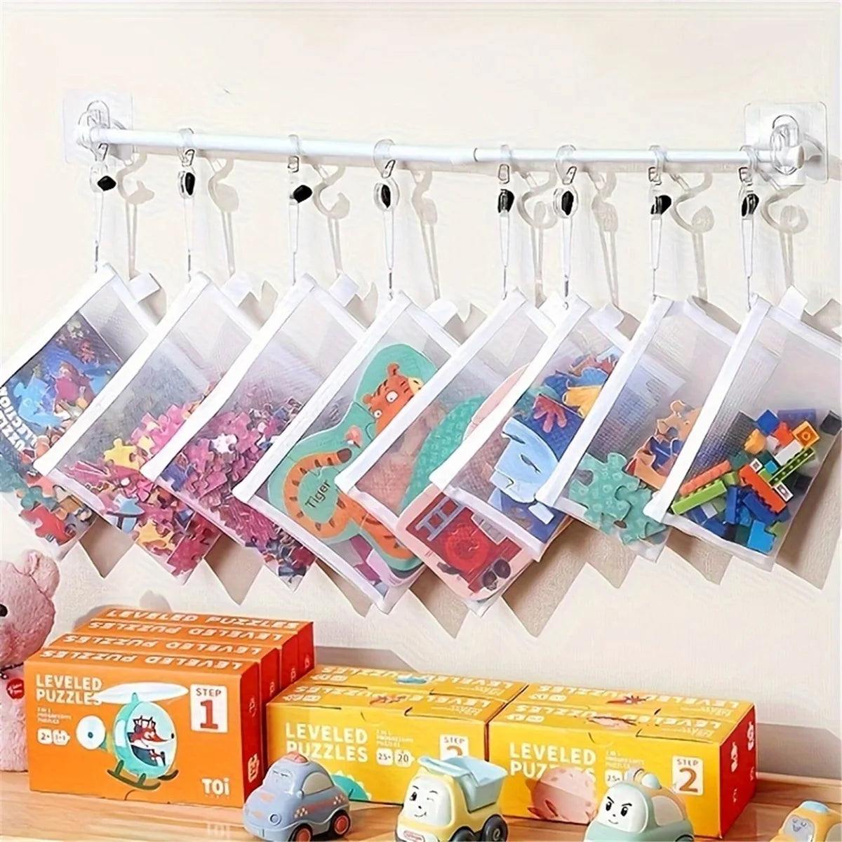 A set of reusable zipper mesh storage bags filled with colorful building toys hanging on a clothesline.