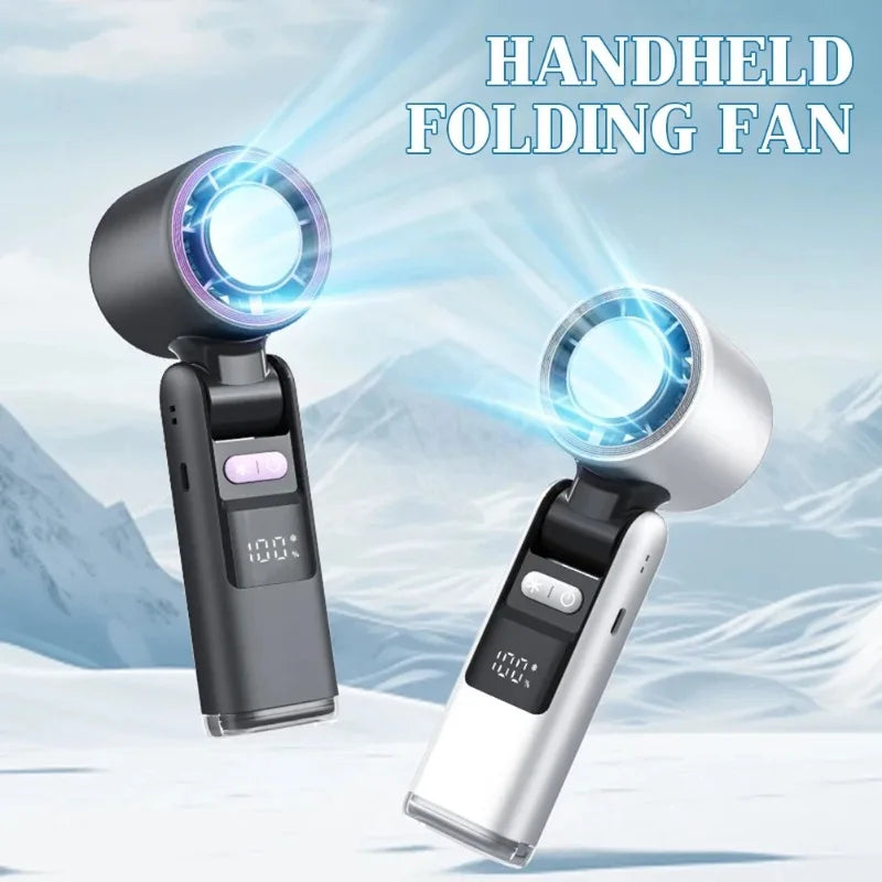 A handheld folding fan with a digital display is shown emitting a cool breeze in a snowy outdoor setting.