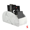 A white marble PU leather caddy organizer holding a smartphone and three TV remotes.