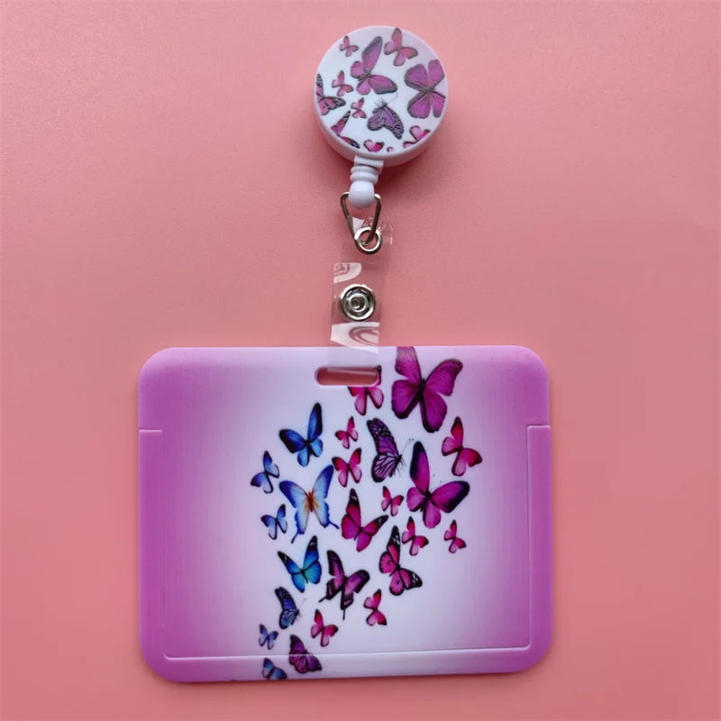 A purple card holder clip featuring a pink butterfly design and a white clip on a pink background.