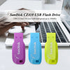 Three SanDisk CZ410 USB flash drives in purple, blue, and yellow colors displayed on a white surface.