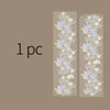 Two vertical strips of decorative silver stamping lace tape featuring floral patterns in purple and white on a beige backgrou