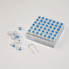 A tray of blue mechanical keyboard switches and a keycap puller set are displayed on a white surface.
