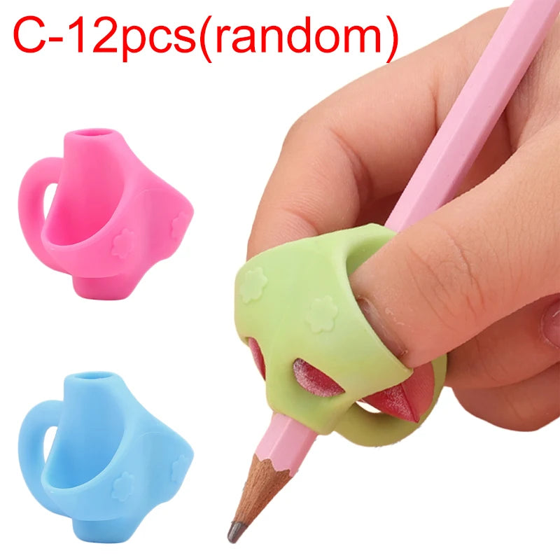 A hand holds a pink silicone pencil grip writing corrector, showing two different colored grips.