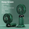 Un ventilador mini portátil verde oscuro con rejilla circular y soporte vertical