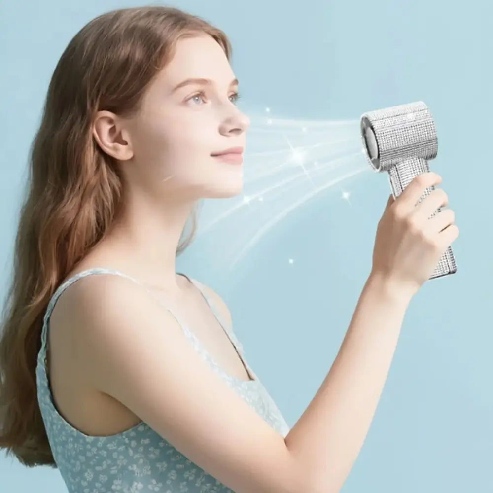 A young woman is using a mini portable LED turbine fan to blow air towards her face.
