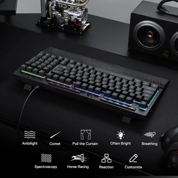 A black Redragon K515 Shiva wired RGB membrane gaming keyboard is shown on a dark surface with various feature icons below it