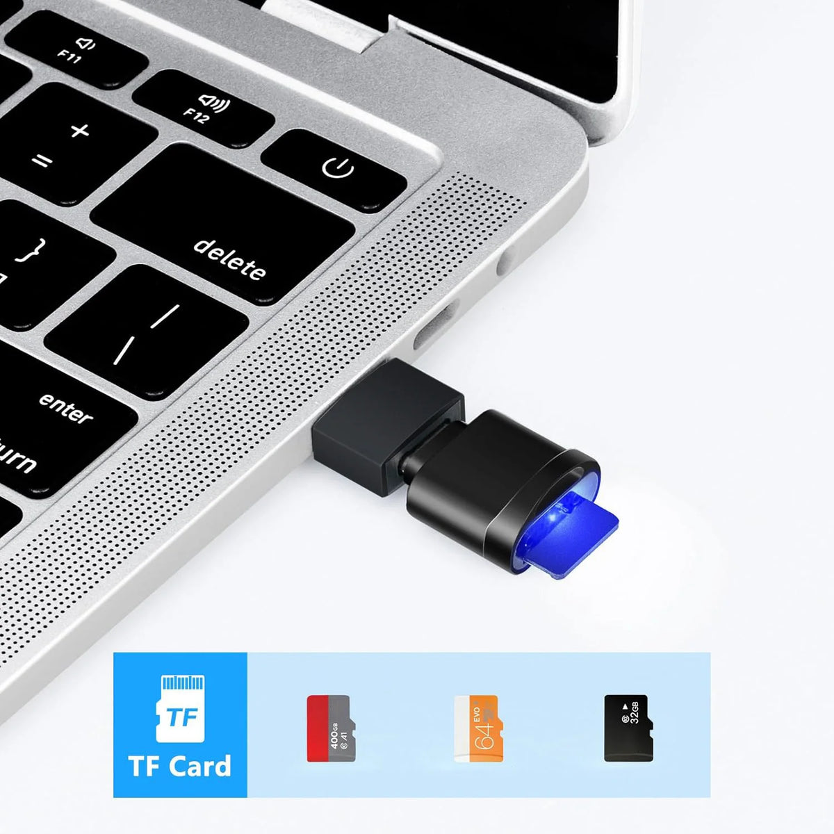 A close-up view of a silver USB-C to SD/TF card reader with a black keychain attachment and various memory cards.