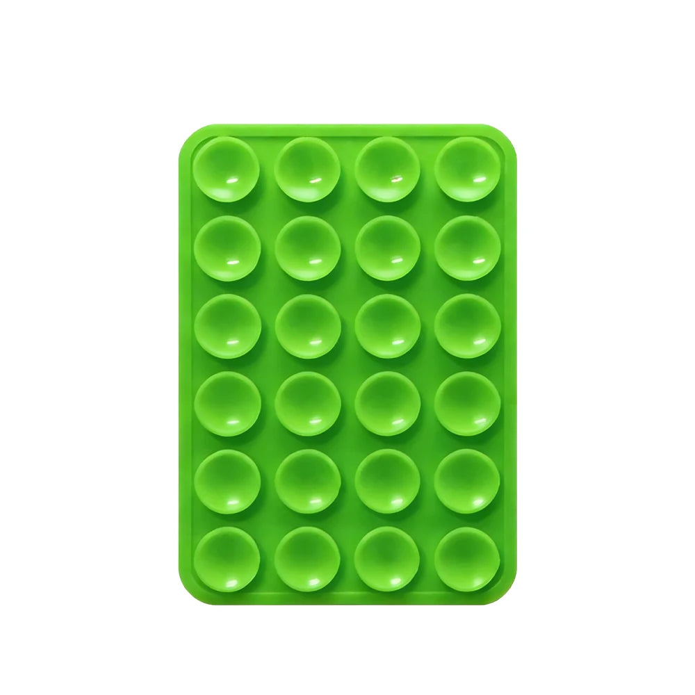 A green silicone suction cup phone mount with multiple circular holes for mounting devices.