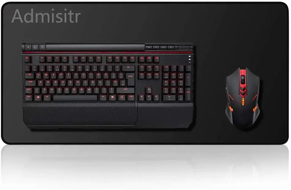 A black mechanical keyboard and an orange gaming mouse are displayed on a dark surface.