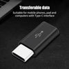 A black USB Type-C to Micro USB adapter converter lying on a dark surface.