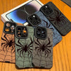 A collection of dark and light gray phone cases featuring a black spider web design displayed on a wooden surface.