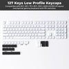 A close-up view of a white low profile mechanical keyboard featuring 127 keys and MX switches.