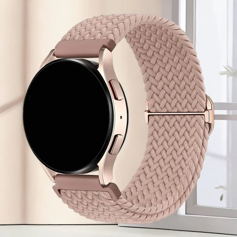 A close-up of a rose gold woven nylon watch strap with a black digital watch face on a light background.
