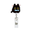 A black cat charm with yellow eyes and a blue tongue attached to a silver retractable ID badge holder.