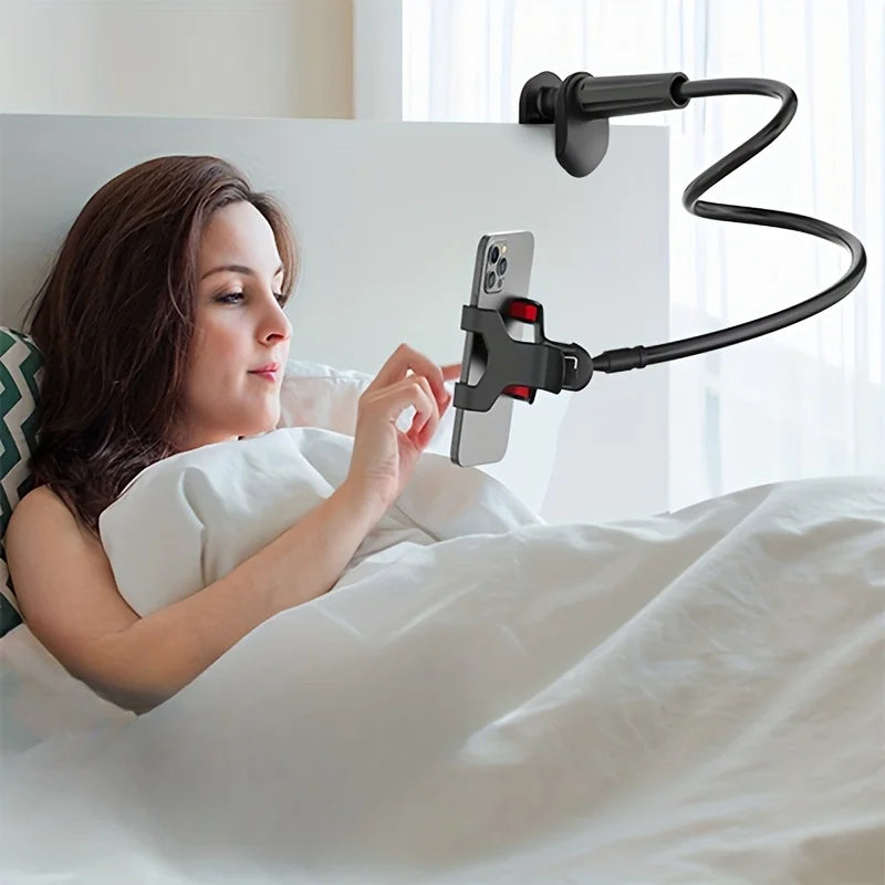 A woman is using a flexible gooseneck phone clamp mount to hold her smartphone above her while lying in bed.