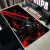 A large black mouse pad featuring a dark, stylized illustration of a character in a fierce pose with red accents.