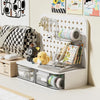 A white desk organizer featuring a pegboard and clear storage drawers for pens, supplies, and small items.