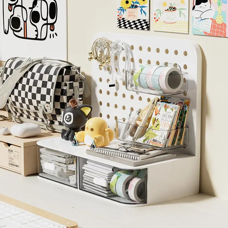 A white desk organizer featuring a pegboard and clear storage drawers for pens, supplies, and small items.