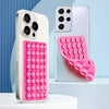 A pink silicone suction cup phone grip is shown next to a silver smartphone, demonstrating its double-sided suction function.