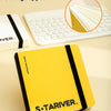 A yellow S&TARIVER drawing book with a hard shell cover and bottom cover shown next to a white laptop.