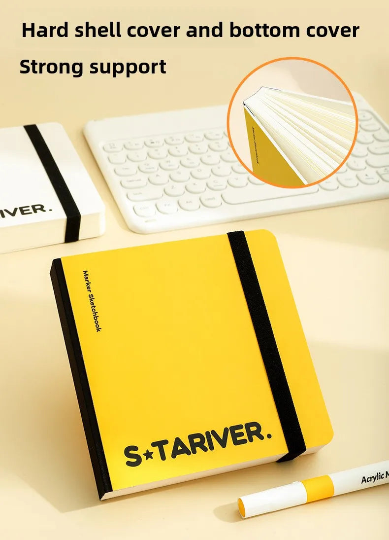 A yellow S&TARIVER drawing book with a hard shell cover and bottom cover shown next to a white laptop.