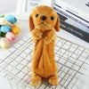 A golden brown plush dog toy sitting on a white wire grid against a background of books and flowers.
