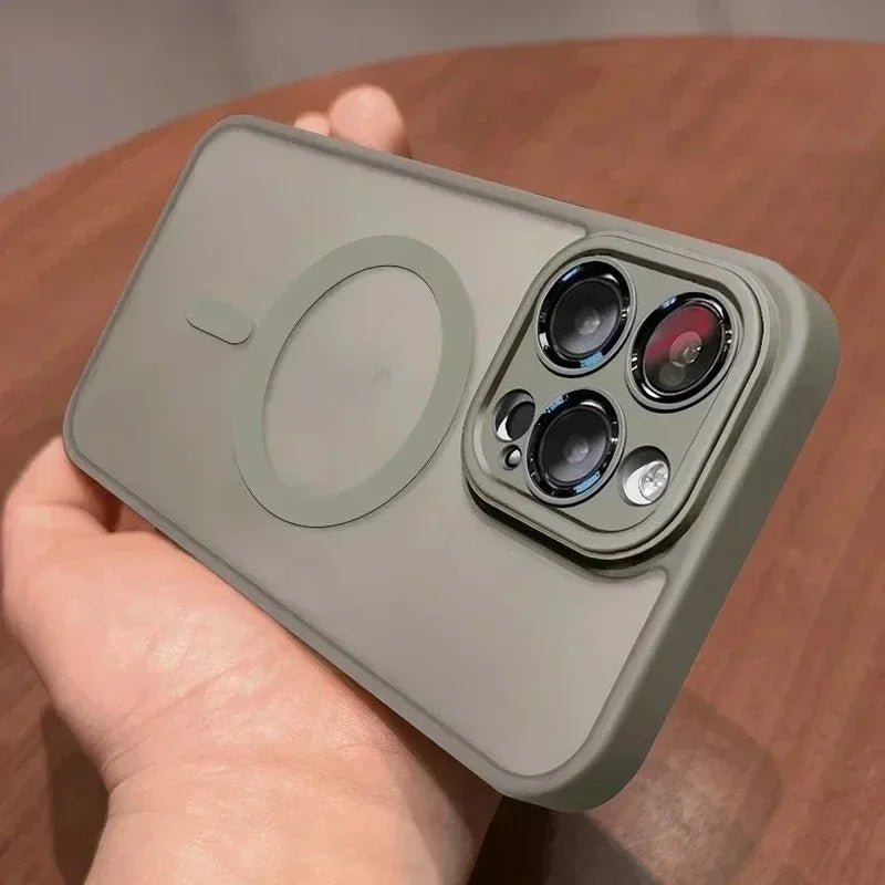 A hand holds a matte olive green magnetic wireless charging lens protector case for an iPhone.