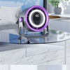 A portable rechargeable desk fan with ambient light is displayed on a glass table next to a window.