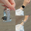 A close-up of a crystal-embellished watch strap with sparkling zircon accents shown on a hand and wrist.