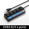 A black USB hub with four ports, featuring individual power switches and blue LED indicators.