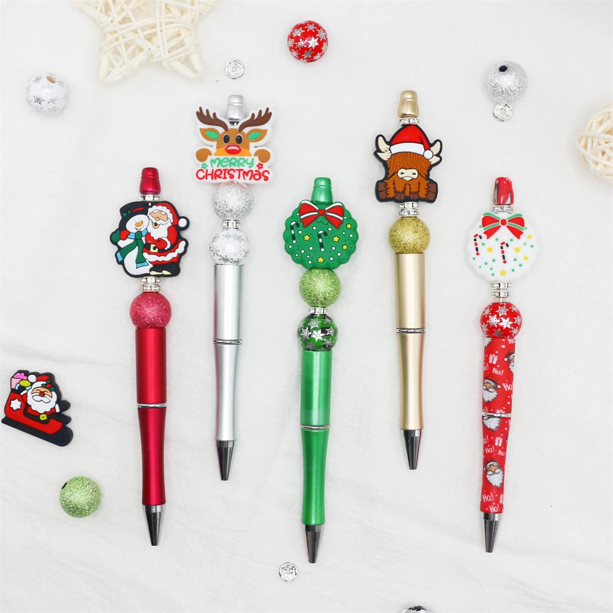 A set of decorative beaded ballpoint pens featuring Christmas and festive designs.