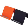 Orange and black flexible silicone phone stand with a sliding mechanism.