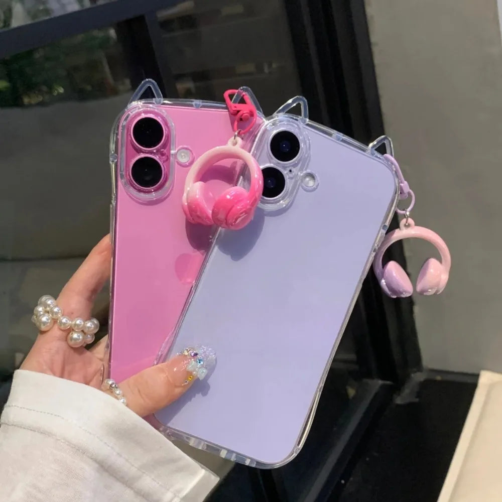 A pink iPhone is shown in a clear case with 3D cat ears and pink headphones attached.