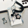 A clear plastic card holder with a black beaded keychain featuring a star charm and a small silver animal figure.