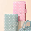 Two reusable PU leather binders in pink and mint green with polka dots, featuring cash pockets.
