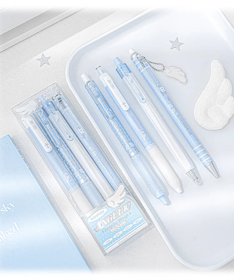 A set of four light blue and white Angelic gel pens with gold accents displayed on a white tray.