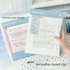 A4 leather clipboard with magnetic closure featuring contrast color design and stitching on a white desk.