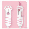 A white retractable cat paw utility knife with pink accents shown against a light pink background.