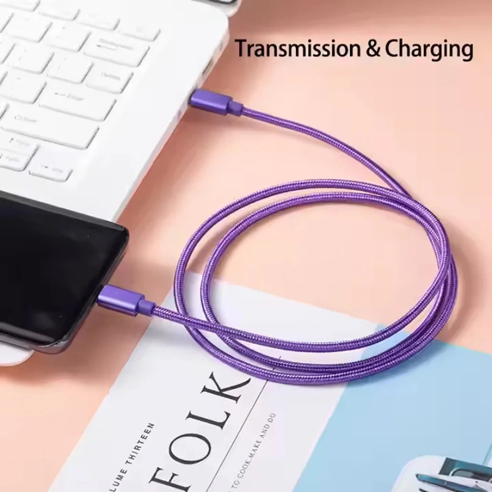A purple USB-C to Type-C charging cable is shown connected to a white laptop and a smartphone.