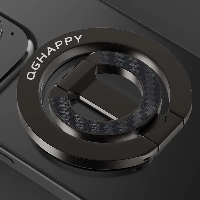 A close-up of a black MagSafe double-sided phone ring holder with a textured surface and a circular design.