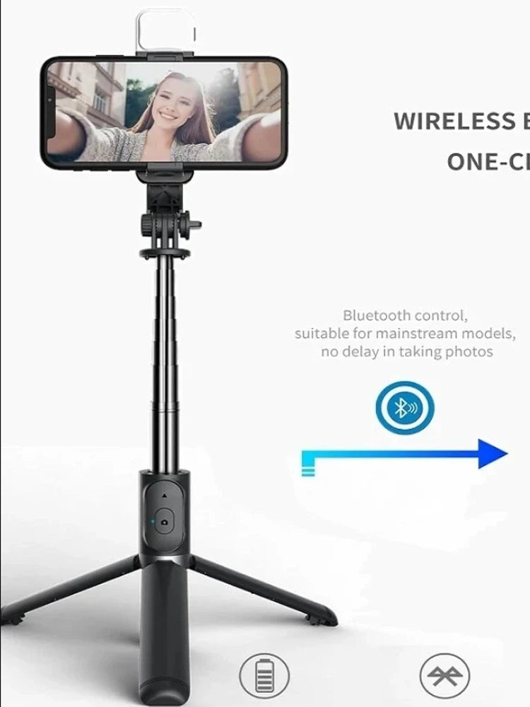 A black selfie stick tripod with a smartphone mounted, featuring a fill light and wireless remote control.
