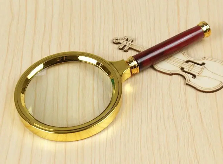 A gold-rimmed magnifying glass with a wooden handle rests next to a violin silhouette.